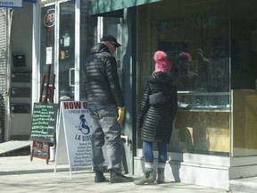 Window shoppers are pictured along Queen St. E. at a jewelry store in the Beaches on March 7, 2021.