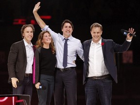 Canada's Prime Minister Justin Trudeau and his wife Sophie Gregoire-Trudeau are flanked by We Day co-founders Craig Kielburger, left, and Marc Kielburger, right.