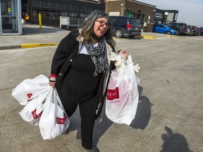 Rita DeMontis, the  Sun's senior national lifestyle and food editor, carries her haul to her car after  enjoying in-store shopping at the HomeSense at Stock Yards Village in Toronto, on March 8, 2021.