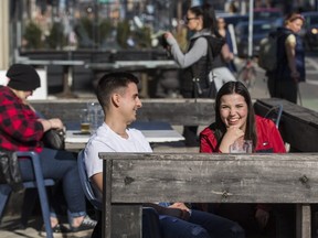 Shayne DeSilva and Brianna Rushlow enjoy the patio at Rivals Sports Pub on Danforth Ave. March 20, 2021.