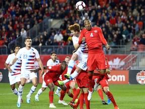 Josh Sargent (No. 19) of the United States goes up for a header against Derek Cornelius (No. 4 )of Canada during a CONCACAF Nations League game at BMO Field on October 15, 2019 in Toronto, Canada. Cornelius was one of 20 players to represent Canada at the CONCACAF Olympic Qualifying tournament in Guadalajara, Mexico starting on March 18.