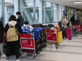 There were long lines of passengers heading to hotels to quarantine on March 1, 2021. Veronica Henri/Toronto Sun/