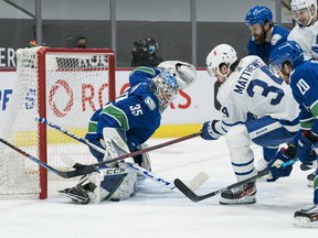 Canucks goalie Thatcher Demko makes a save on Maple Leafs forward  Auston Matthews (34) in the third period at Rogers Arena.