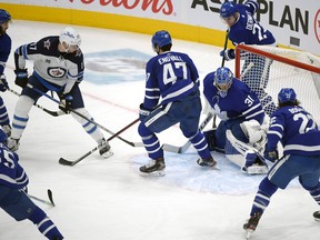 Winnipeg Jets forward Adam Lowry (17) scores against Toronto Maple Leafs in the third period at Scotiabank Arena.