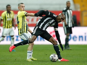 Fenerbahce's Dimitris Pelkas in action with Besiktas midfielder Atiba Hutchinson on March 21, 2021.