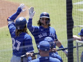 Blue Jays shortstop Bo Bichette (11) is congratulated by teammates after hitting a home run during the first inning against the New York Yankees at George M. Steinbrenner Field on Tuesday.