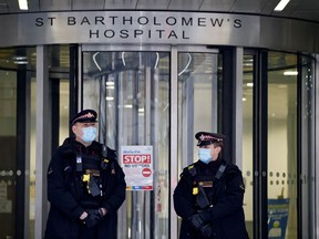 Police officers stand on duty outside St Bartholomew's Hospital, commonly known as St Barts, in central London on March 4, 2021 where Prince Philip, Duke of Edinburgh was transferred to on March 1.