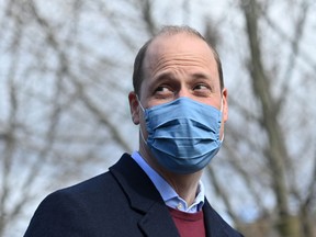 Prince William, Duke of Cambridge, reacts to a question from the media as he leaves after a visit to School21 following its reopening after the easing of coronavirus lockdown restrictions in east London on March 11, 2021.