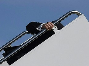 U.S. President Joe Biden trips while boarding Air Force One at Joint Base Andrews in Maryland on March 19, 2021.