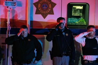 Law enforcement personnel salutes as the motorcade carrying fallen Boulder Police officer Eric Talley exits the King Soopers grocery store in Boulder, Colorado on March 22, 2021 after a mass shooting on March 22, 2021. - A gunman killed at least 10 people including a police officer at a grocery store in Colorado on Monday, March 22, police said, in the latest shooting to hit the western state -- scene of two of the most infamous US mass murders.

The shooter is being held in custody and was injured, said Michael Dougherty, district attorney for Boulder County, located 30 miles (50 kilometers) northwest of the state capital Denver. (Photo by Jason Connolly / AFP) (Photo by JASON CONNOLLY/AFP via Getty Images)