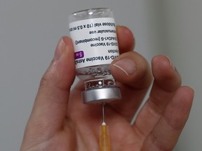 A healthcare worker draws a dose of the AstraZeneca COVID-19 vaccine at the Clinique de l'Estree in France, March 5, 2021.