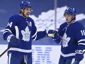Toronto Maple Leafs centre Auston Matthews, left, celebrates his power play goal against the Ottawa Senators with teammate Leafs right wing Mitchell Marner during first period NHL hockey action in Toronto on Thursday, Feb. 18, 2021.