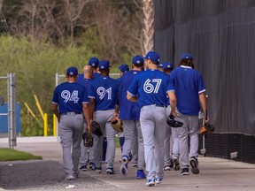 Toronto Blue Jays players head off of the practice field during spring training in Dunedin, Fla. on Feb. 23, 2021.
