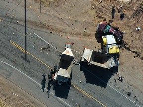 California Highway Patrol officers investigate a crash site after a collision between a Ford Expedition and a tractor-trailer truck near Holtville, California, in an aerial photograph March 2, 2021.