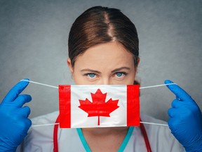 Coronavirus in Canada Female Doctor Portrait hold protect Face surgical medical mask with Canada National Flag. Illness, Virus Covid-19 in Canada, concept photo