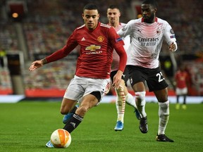 Manchester United's English striker Mason Greenwood (left) takes on AC Milan's Canada-born English defender Fikayo Tomori on Thursday. (AP)