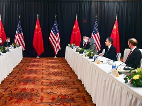 U.S. Secretary of State Antony Blinken (second right), joined by National Security Adviser Jake Sullivan (right), speaks while facing Yang Jiechi (second left), director of the Central Foreign Affairs Commission Office, and Wang Yi (left), China's State Councilor and Foreign Minister, at the opening session of U.S.-China talks at the Captain Cook Hotel in Anchorage, Alaska, March 18, 2021.