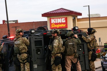 Law enforcement officers in tactical gear are seen at the site of a shooting at a King Soopers grocery store in Boulder, Colorado, U.S. March 22, 2021.  REUTERS/Kevin Mohatt ORG XMIT: GGG-BOU200