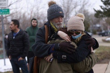Sarah Moonshadow is comforted by David and Maggie Talley after Moonshadow was inside King Soopers during a shooting in Boulder, Colorado, U.S. March 22, 2021.  REUTERS/Alyson McClaran ORG XMIT: GGG-BOU100