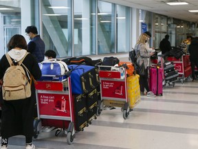 Passengers at Toronto Pearson airport wait to head to hotels to quarantine on Monday, March 1, 2021.