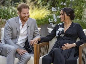 This image provided by Harpo Productions shows Prince Harry, left, and Meghan, Duchess of Sussex, speaking about expecting their second child during an interview with Oprah Winfrey.