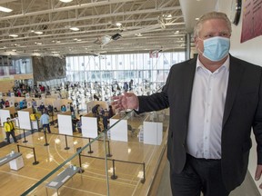 Ontario Premier Doug Ford tours a COVID-19 mass vaccination clinic in Toronto on Monday, March 8, 2021.