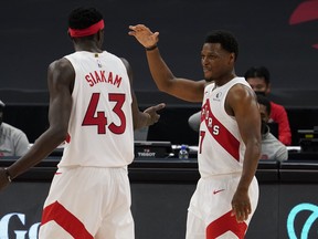 Toronto Raptors guard Kyle Lowry (7) celebrates with forward Pascal Siakam (43) as the pair is taken out of the game against the Denver Nuggets during the second half of an NBA basketball game Wednesday, March 24, 2021, in Tampa, Fla.