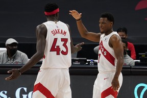 Toronto Raptors guard Kyle Lowry (7) celebrates with forward Pascal Siakam (43) as the pair is taken out of the game against the Denver Nuggets during the second half of an NBA basketball game Wednesday, March 24, 2021, in Tampa, Fla.