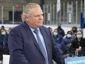 Ontario Premier Doug Ford listens to a question during the daily briefing at a mass vaccination centre in Toronto on Tuesday, March 30, 2021.