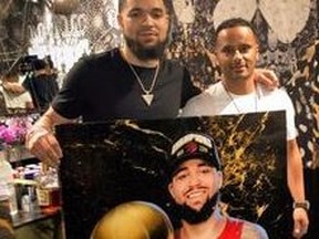 Amer SM (right) and  Toronto Raptor Fred  Vanvleet stand behind a custom portrait of the basketball star.