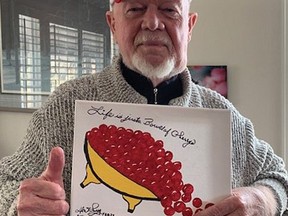 Hockey legend Grapes gives his classic thumbs up while holding his creation called Life is a Bowl of Cherrys, a painting that will be auctioned off to raise money for the Don Cherry Pet Rescue Foundation.