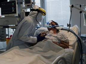 Health staff attends to a patient at the  COVID-19 dedicated ICU unit of the Tras-Os-Montes E Alto Douro Hospital, in Vila Real, Portugal Feb. 22, 2021.