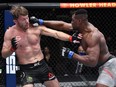 In this handout image provided by UFC, Francis Ngannou of Cameroon, left, punches Stipe Miocic in their UFC heavyweight championship fight during the UFC 260 event at UFC APEX on March 27, 2021 in Las Vegas, Nevada.