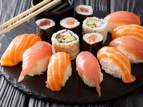 set of sushi and rolls with salmon and tuna, avocado, california, maki, soy sauce, chopsticks close-up. horizontal