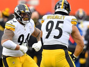Tyson Alualu, left, and Chris Wormley of the Pittsburgh Steelers celebrate after Wormley's sack against the Cleveland Browns in the second quarter at FirstEnergy Stadium on Jan. 3, 2021 in Cleveland, Ohio.