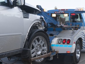 A damaged vehicle on a tow truck.
