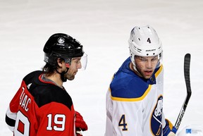 Devils’ Travis Zajac (left) and Sabres’ Taylor Hall look on during a game on Tuesday, March 16 in New Jersey. ELSA/GETTY IMAGES