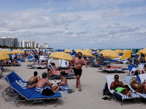 Revelers flock to the beach to celebrate spring break, amid the COVID-19 outbreak in Miami Beach March 6, 2021. REUTERS/Marco Bello/File Photo ORG XMIT: FW1