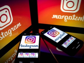 In this file photo taken on Sept. 28, 2020 shows the logo of the social network Instagram on a smartphone and a tablet screen in Toulouse, France.