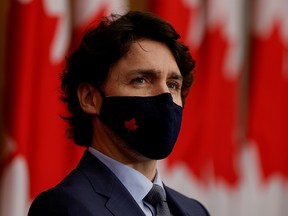 Prime Minister Justin Trudeau, wearing a protective mask, attends a news conference in Ottawa March 5, 2021.