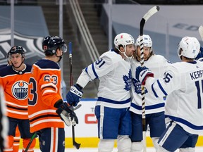 Maple Leafs’ William Nylander (centre) celebrates with teammates after scoring a goal on Oilers goaltender Mike Smith at Rogers Place in Edmonton, on Wednesday, March 3, 2021.