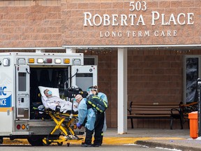 Paramedics transport a person from Roberta Place, a long term seniors care facility which is the site of a coronavirus outbreak, in Barrie January 18, 2021.