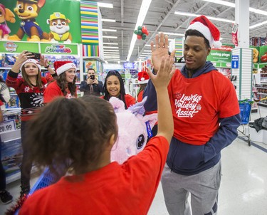 Toronto Raptor Kyle Lowry works the crowd as students from St. Stephen Catholic School are in the middle of a $400 shopping spree at Toys ÔRÕ Us Sherway Gardens in Toronto, Ont. on Monday December 18, 2017.  For the third year in a row Toronto Raptors All-Star Kyle Lowry, and his wife, Ayahna brought some unexpected Christmas cheer to young kids. As a part of Kyle LowryÕs Holiday Assist program, 26 students from St. Stephen Catholic School got a chance to spend $400 on whatever they wanted from the Toys ÔRÕ Us. Ernest Doroszuk/Toronto Sun/Postmedia Network