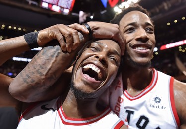 Toronto Raptors' Kyle Lowry, left, and DeMar DeRozan celebrate after defeating the Milwaukee Bucks in NBA basketball action in Toronto on Monday, January 1, 2018. THE CANADIAN PRESS/Frank Gunn ORG XMIT: FNG514 ORG XMIT: POS1801012126010794