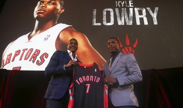 Raptors Kyle Lowry (right) pose with Raptors president and general manager Masai Ujiri . The Toronto Raptors announced that they have re-signed their six-foot tall point guard Kyle Lowry to a multi-year deal worth an estimated $48 million over four yearson Thursday July 10, 2014. Jack Boland/Toronto Sun/QMI Agency