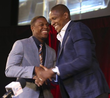 Raptors Kyle Lowry is hugged by Raptors president and general manager Masai Ujiri (right) The Toronto Raptors announced that they have re-signed their six-foot tall point guard Kyle Lowry to a multi-year deal worth an estimated $48 million over four yearson Thursday July 10, 2014. Jack Boland/Toronto Sun/QMI Agency