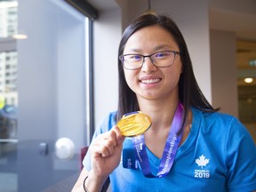 Maggie Mac Neil of London shows off her gold medal she won in the World Championships in Gangju South Korea in 2019.