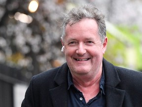 Journalist and television presenter Piers Morgan smiles as he walks near his house, after he left his high-profile breakfast slot with the broadcaster ITV, following his long-running criticism of Prince Harry's wife Meghan, in London, March 10, 2021.