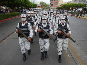Members of the National Guard march during the announcement of the new measures by the Mexican government to deter illegal crossings at the southern border with Guatemala, in Tuxtla Gutierrez, Mexico March 19, 2021.