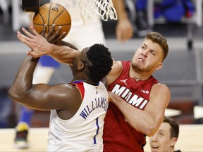 Meyers Leonard, right, of the Miami Heat fouls Zion Williamson of the New Orleans Pelicans during the second quarter at American Airlines Arena on Dec. 25, 2020 in Miami, Fla.